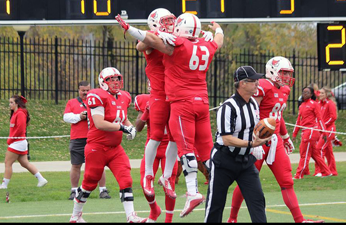 Marist's Matt Tralli celebrates with one of his offensive linemen following a touchdown, Saturday. (Photo courtesy Marist Athletics)